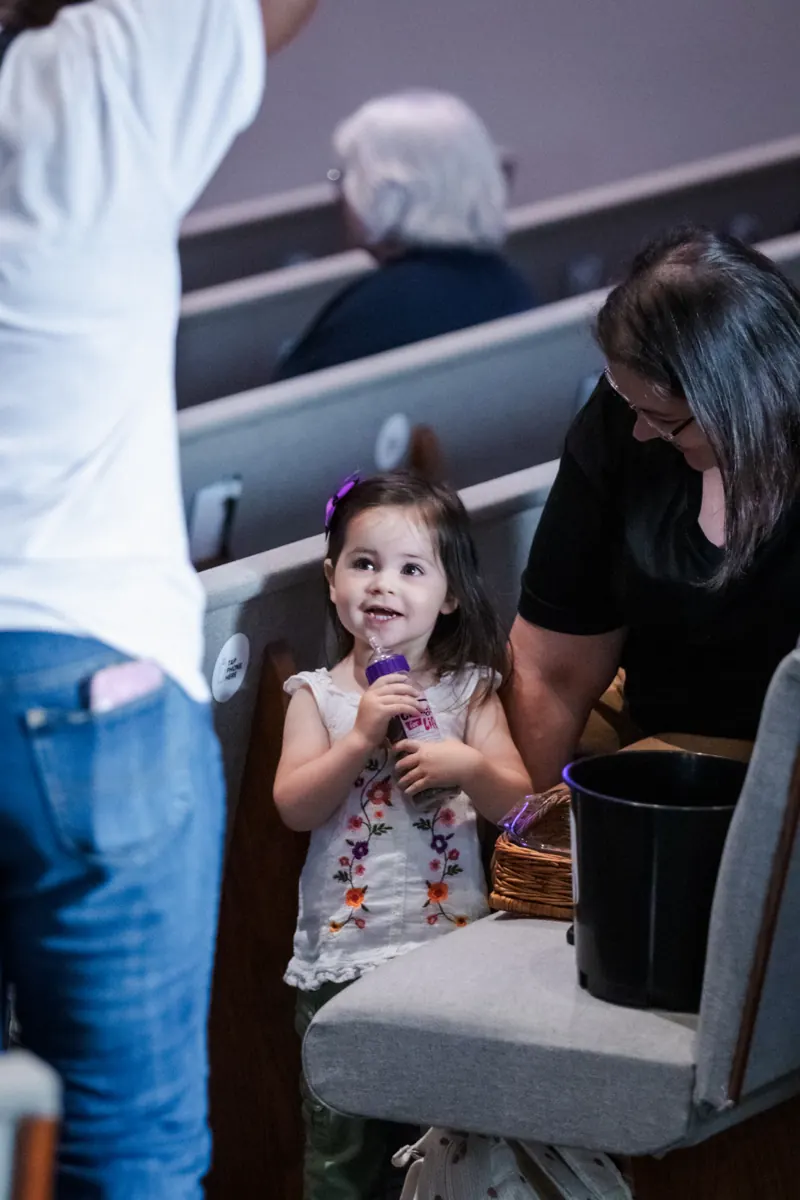 A little girl smiling during service